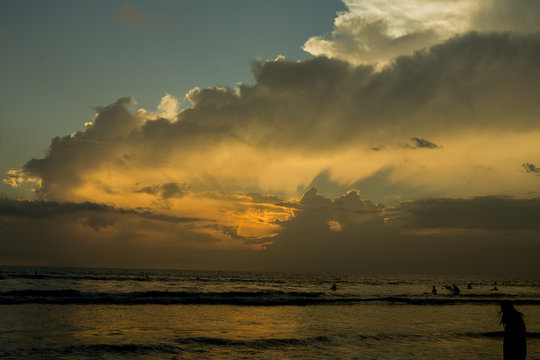Beautiful sunset of Kuta Beach, Bali, Indonesia. Silhouettes of people at sunset on Kuta beach in Bali, Indonesia
