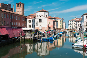 Fototapeta na wymiar Reflections along the canals of Chioggia, Venice and its lagoon.