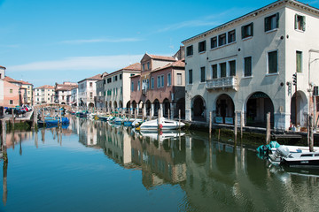 Obraz premium Reflections along the canals of Chioggia, Venice and its lagoon.