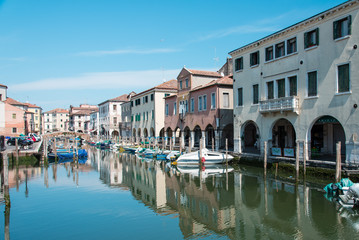Obraz premium Reflections along the canals of Chioggia, Venice and its lagoon.