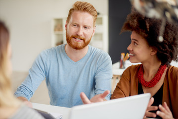 Multi-ethnic group having a meeting or presentation in modern office