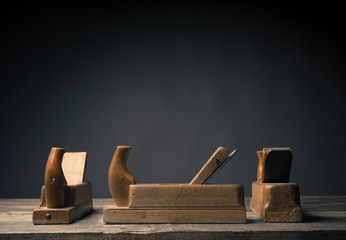 Old wood plane on rustic plank