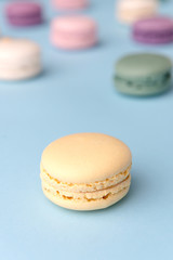 Sweet colorful macaroons on blue table background