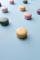 Sweet colorful macaroons on blue table background.