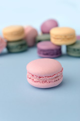 Sweet colorful macaroons on blue table background
