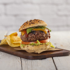 Delicious burger with beef, tomato, cheese and lettuce 