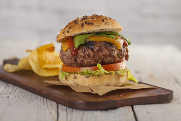 Delicious burger with beef, tomato, cheese and lettuce 