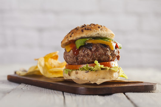 Delicious burger with beef, tomato, cheese and lettuce 