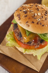 Delicious burger with beef, tomato, cheese and lettuce 