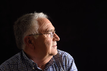 Portrait of a senior man with black background