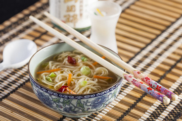 Asian soup with noodles in a decorated bowl