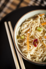 Asian soup with noodles in a decorated bowl