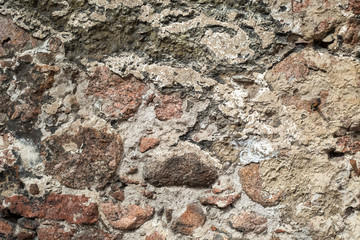 Wallpaper granite stones in cement . Pattern grey red style vintage rough round decorative real stone wall surface with cement.