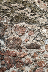 Wallpaper granite stones in cement . Pattern grey red style vintage rough round decorative real stone wall surface with cement.