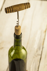 Wine glass and bottle on a wooden table with bricks wall background