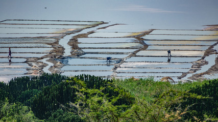 Long shot of saltmine at dusk with workers