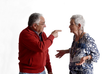 A senior couple arguing on white background