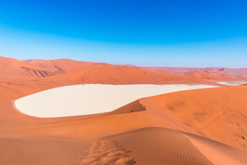Plakat The scenic Sossusvlei and Deadvlei, clay and salt pan surrounded by majestic sand dunes. Namib Naukluft National Park, travel destination in Namibia. Ultra wide.