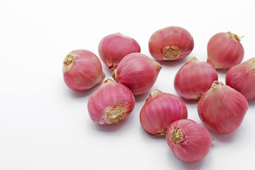 Closeup Pile of Red Onions on White Background