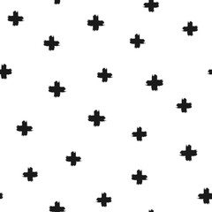 Randomly scattered crosses painted with a rough brush. Seamless pattern.