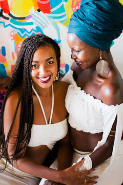 Young beautiful African female friends in white dress