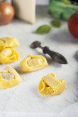 Raw and fresh big tortellini in a marble table