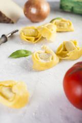 Raw and fresh big tortellini in a marble table