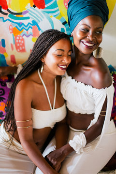 Young beautiful African female friends in white dress