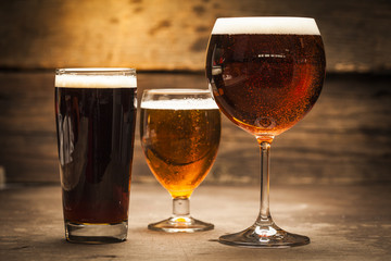 Glasses of beer on a wooden background