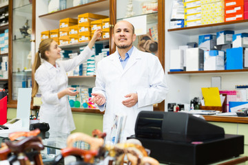 Two orthopedists working in special store with orthopaedic goods