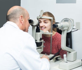 Ophthalmologist and woman checking eyesight
