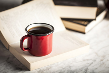 Coffee cup with books at the background