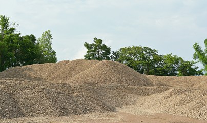 The river gravel pile is sold for cement use in construction.