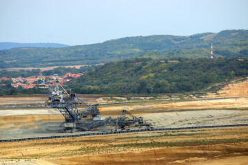 giant excavator digging on open pit coal mine