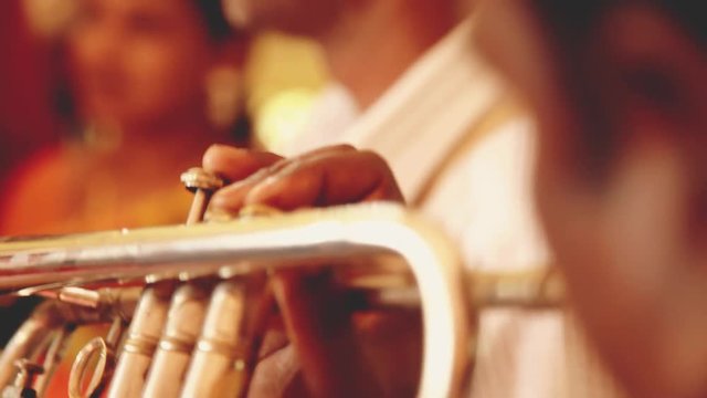 Man plays the trumpet for Indian wedding
