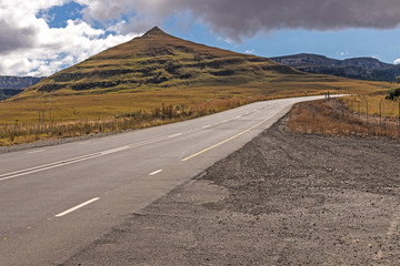 Asphalt Road Running Through Dry Orange Winter Mountain Landscape
