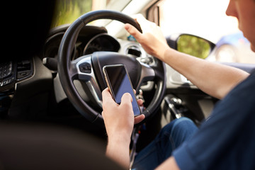 Young Man Sending Text Message Whilst Driving