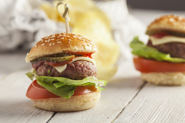     Deluxe gourmet burger on wooden table 