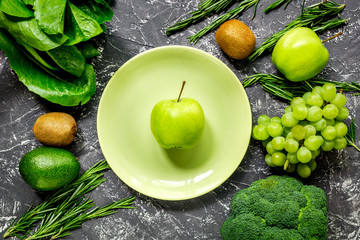 healthy green food with fresh vegetables on dark table background top view