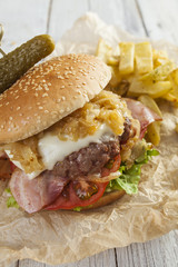     Deluxe gourmet burger on wooden table 