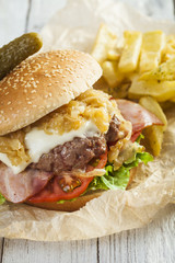     Deluxe gourmet burger on wooden table 