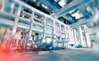 Industrial Factory. Various mechanisms and metal pipes. Toned image. Motion blur effect.