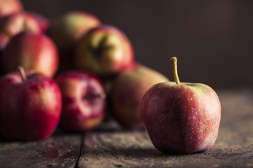 Red apples on wooden background