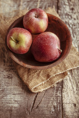 Red apples on wooden background