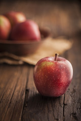 Red apples on wooden background
