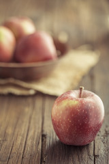Red apples on wooden background