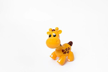 Plastic toy giraffe on a white background