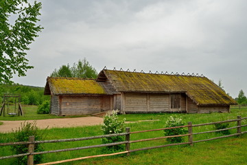Fototapeta na wymiar Old wooden log barn in the Museum of Pushkin Mikhailovskoe village