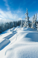 Fototapeta premium Snowdrifts on winter snow covered mountainside