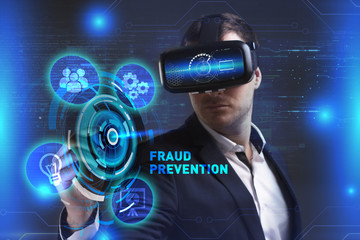 Business, Technology, Internet and network concept. Young businessman working in virtual reality glasses sees the inscription: Fraud prevention